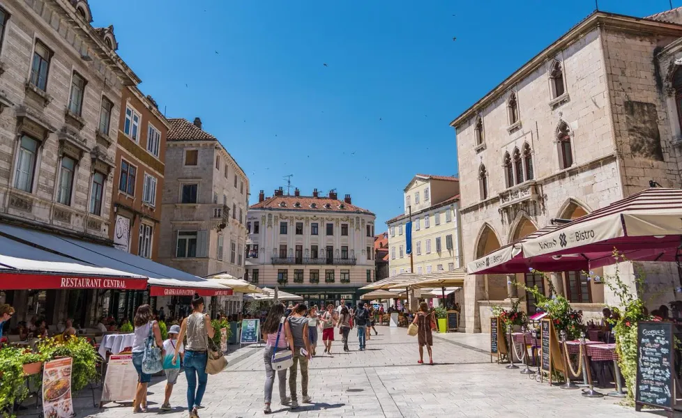 Tourists exploring a beautiful square in Split, Croatia.