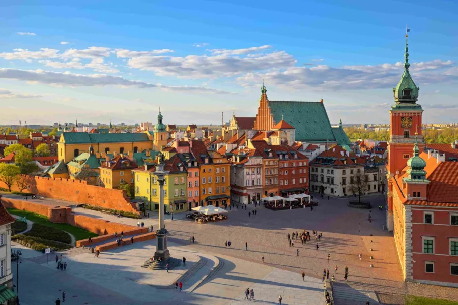 Panoramic view of Warsaw's Old Town Square at sunset.