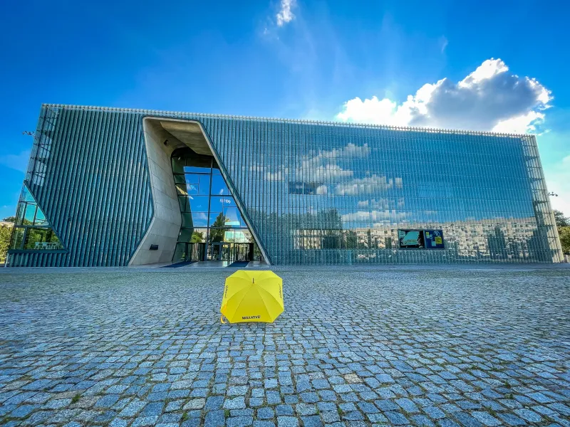 Yellow umbrella in front of the POLIN Museum in Warsaw.