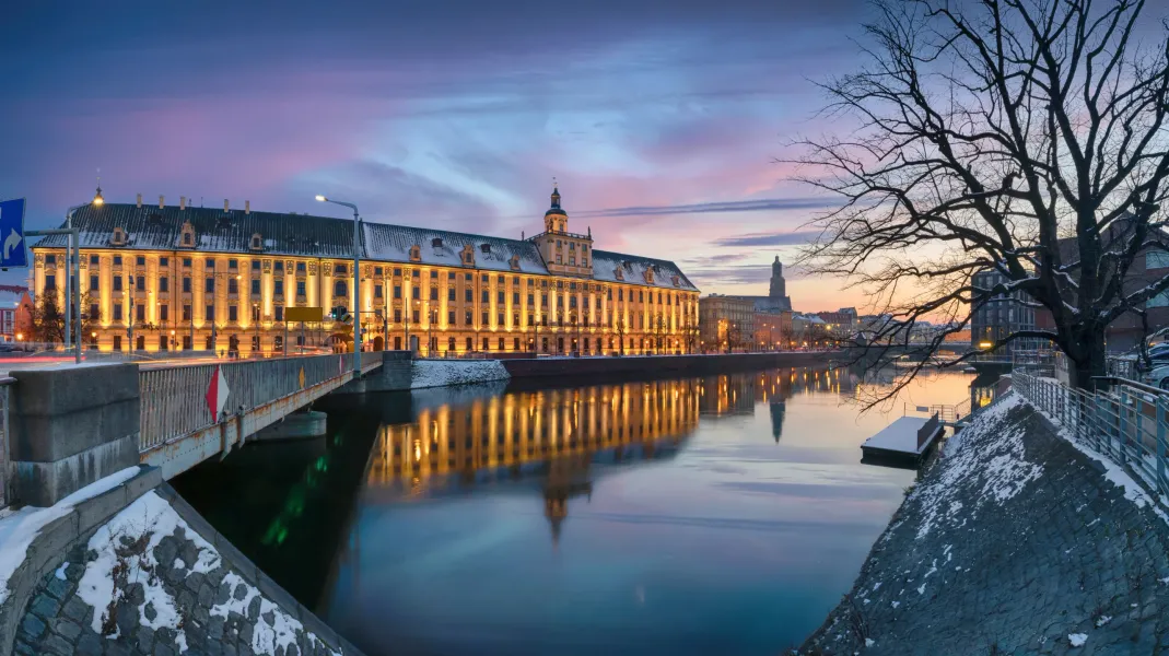 University of Wrocław at twilight, reflected in the Odra River.