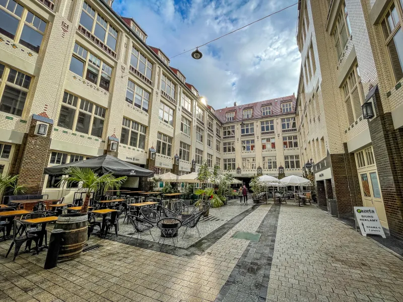 Picturesque courtyard in Wrocław, Poland, with cafes and restaurants.
