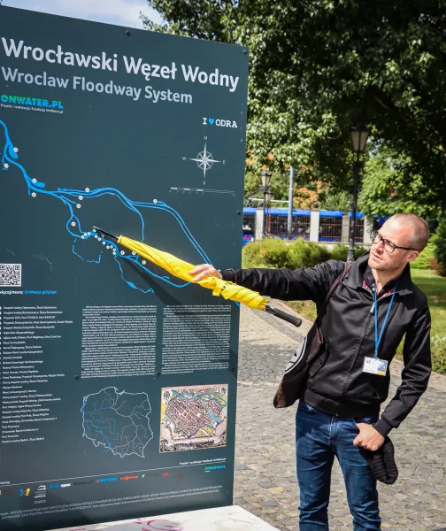 A tour guide in Wrocław, Poland, points to a map of the city's floodway system.