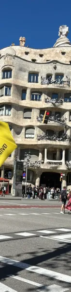 Antoni Gaudí's La Pedrera (Casa Milà) in Barcelona, with its wavy stone facade, iron balconies, and unique rooftop element...
