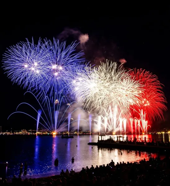 Fireworks display over water.
