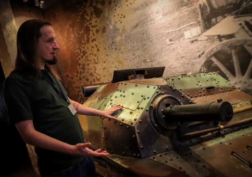 The guide explaining World War Two tankette exhibit inside Schindler's Factory Museum in Krakow, Poland.