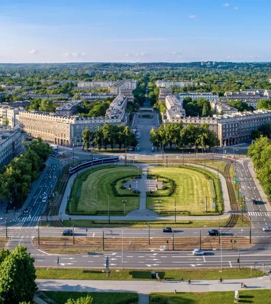 Aerial view of Plac Centralny in Nowa Huta, Krakow, showing its symmetrical layout, buildings, and green spaces on a sunny...