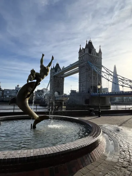 The Girl with a Dolphin fountain on the bank of the Thames, with Tower Bridge and the Shard in the background.