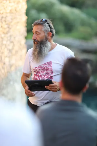 A tour guide leads a group on a walking tour.
