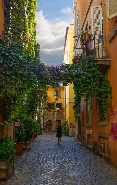 Charming alleyway in Rome with lush greenery.