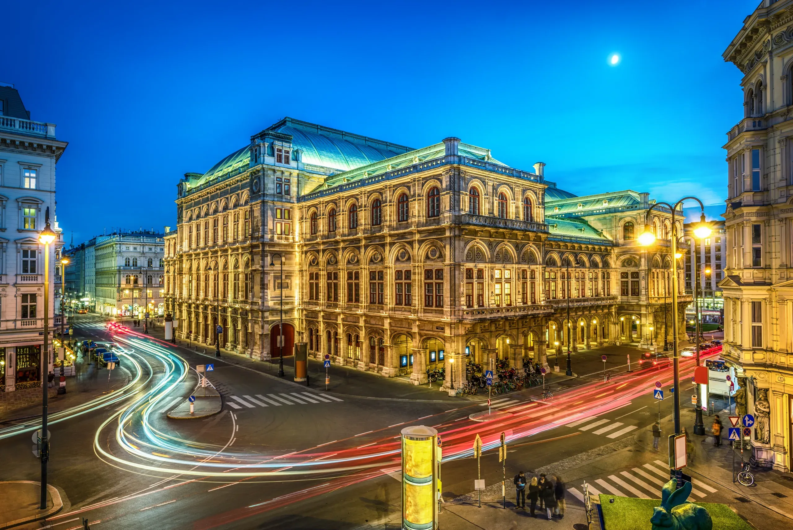 Vienna State Opera at night, illuminated beautifully.