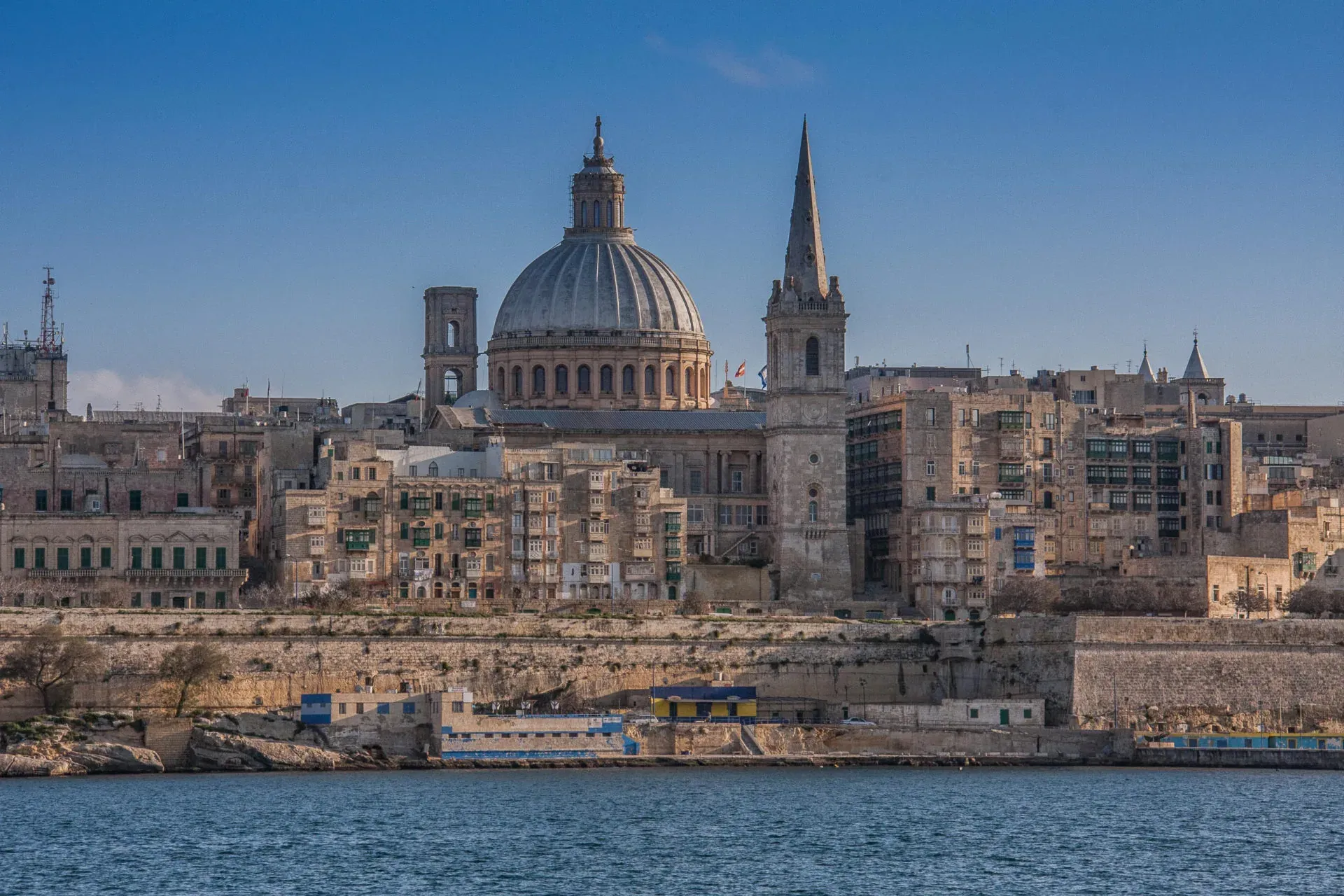 Valletta skyline from the sea, showing the dome of Our Lady of Mount Carmel Basilica, St Paul's Pro-Cathedral spire, and hist