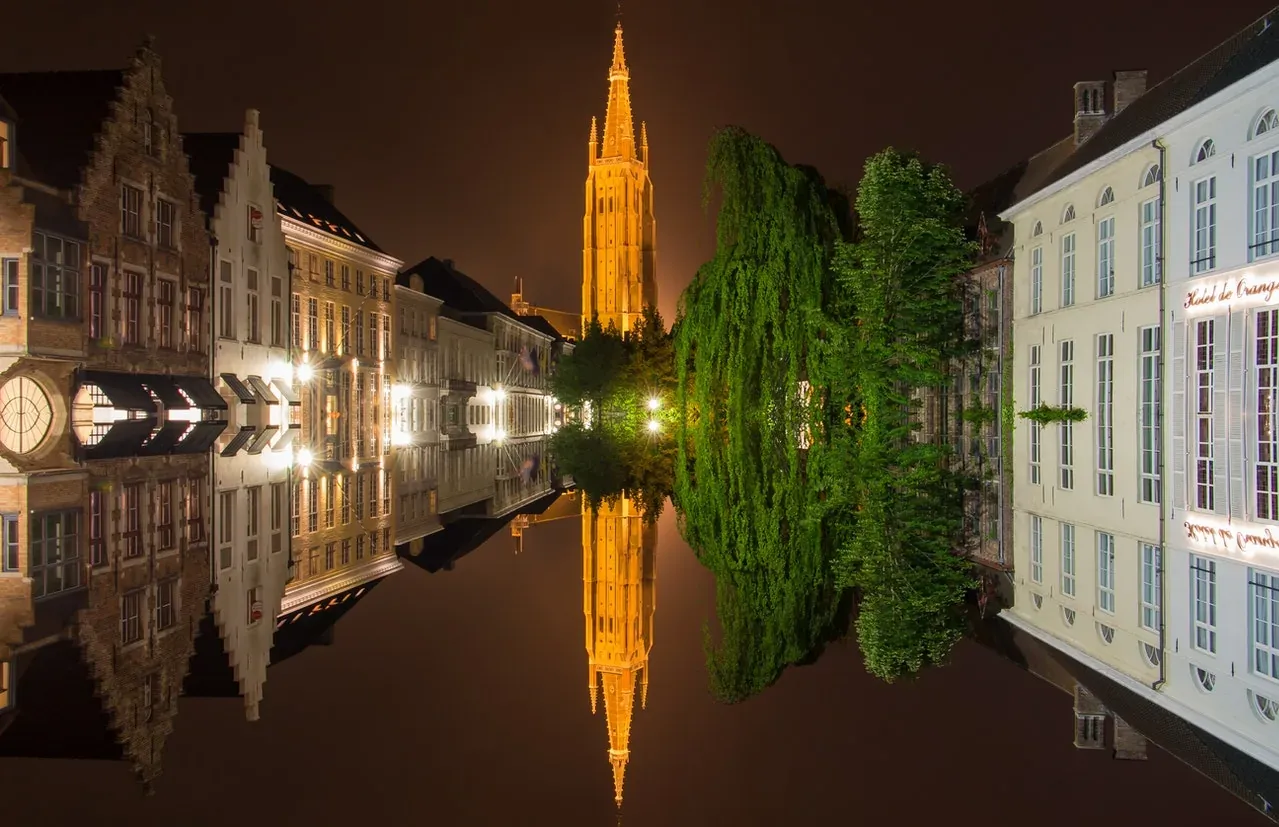 Bruges by Night: Stunning reflection of the Belfry and canals.