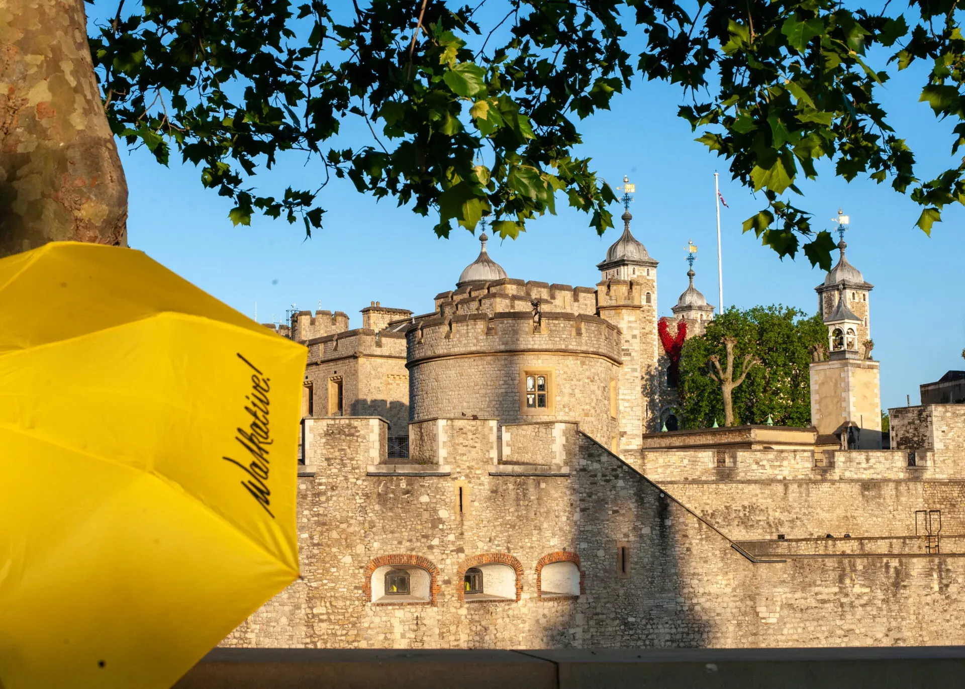 Yellow Walkative umbrella in front of the Tower of London.