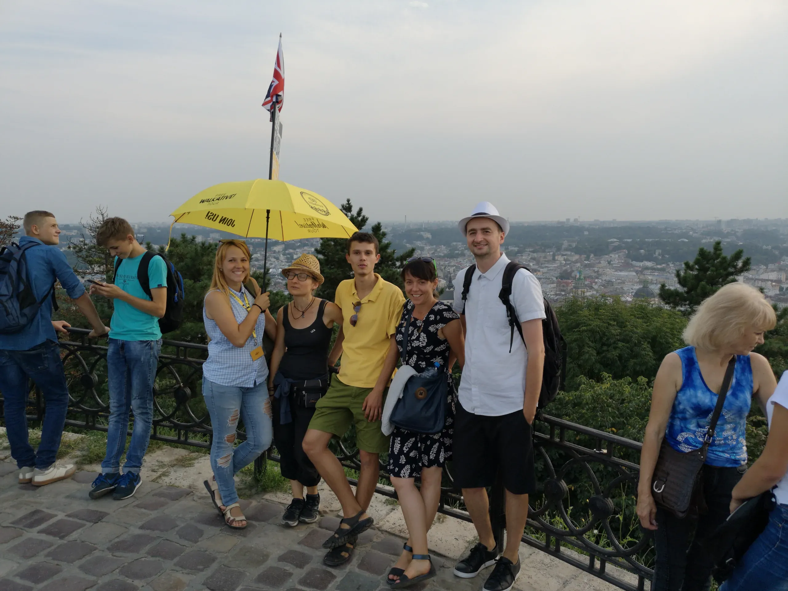A guided walking tour group in Lviv, Ukraine, enjoying a panoramic city view.