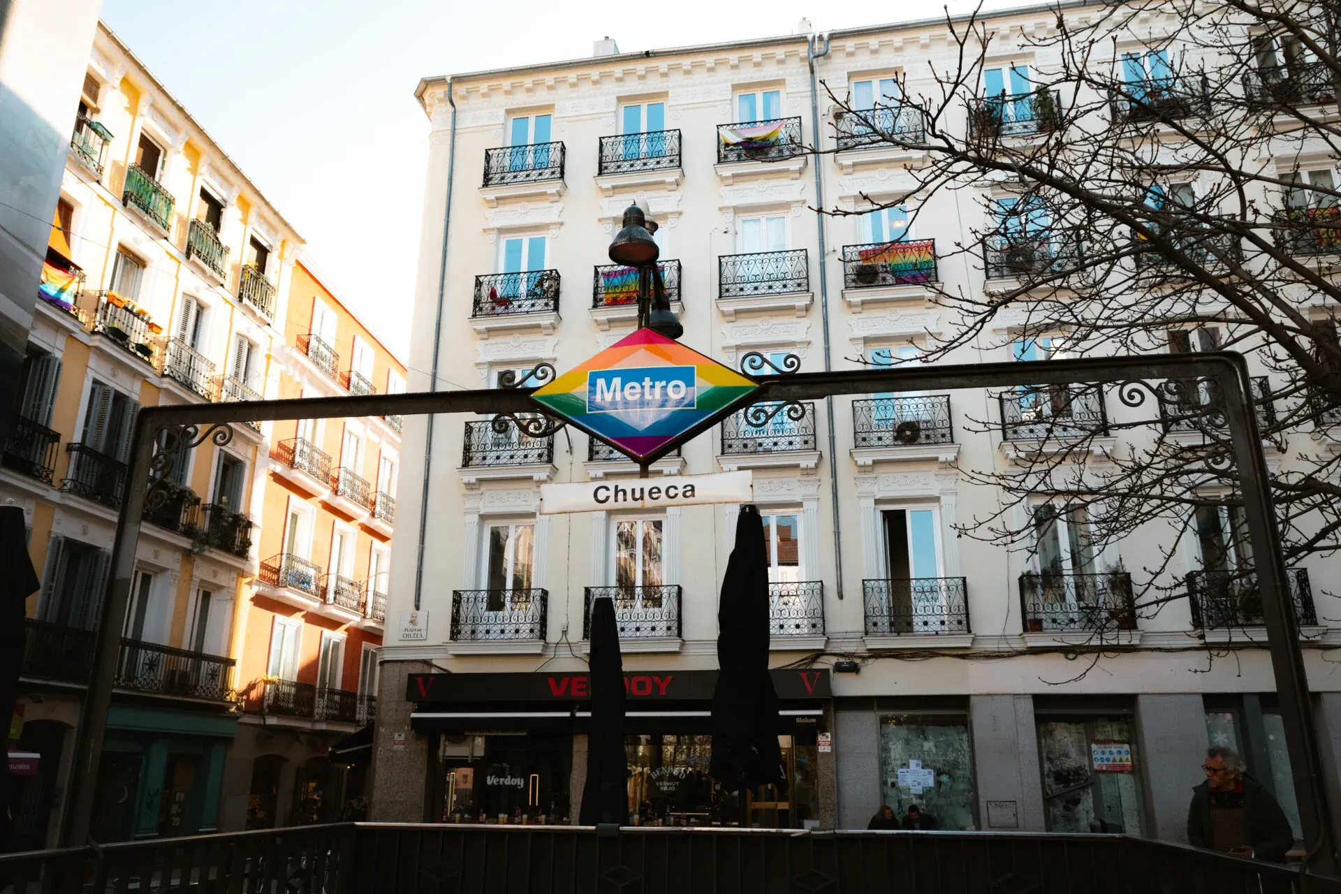 Madrid's Chueca neighborhood: A vibrant metro sign and colorful buildings.