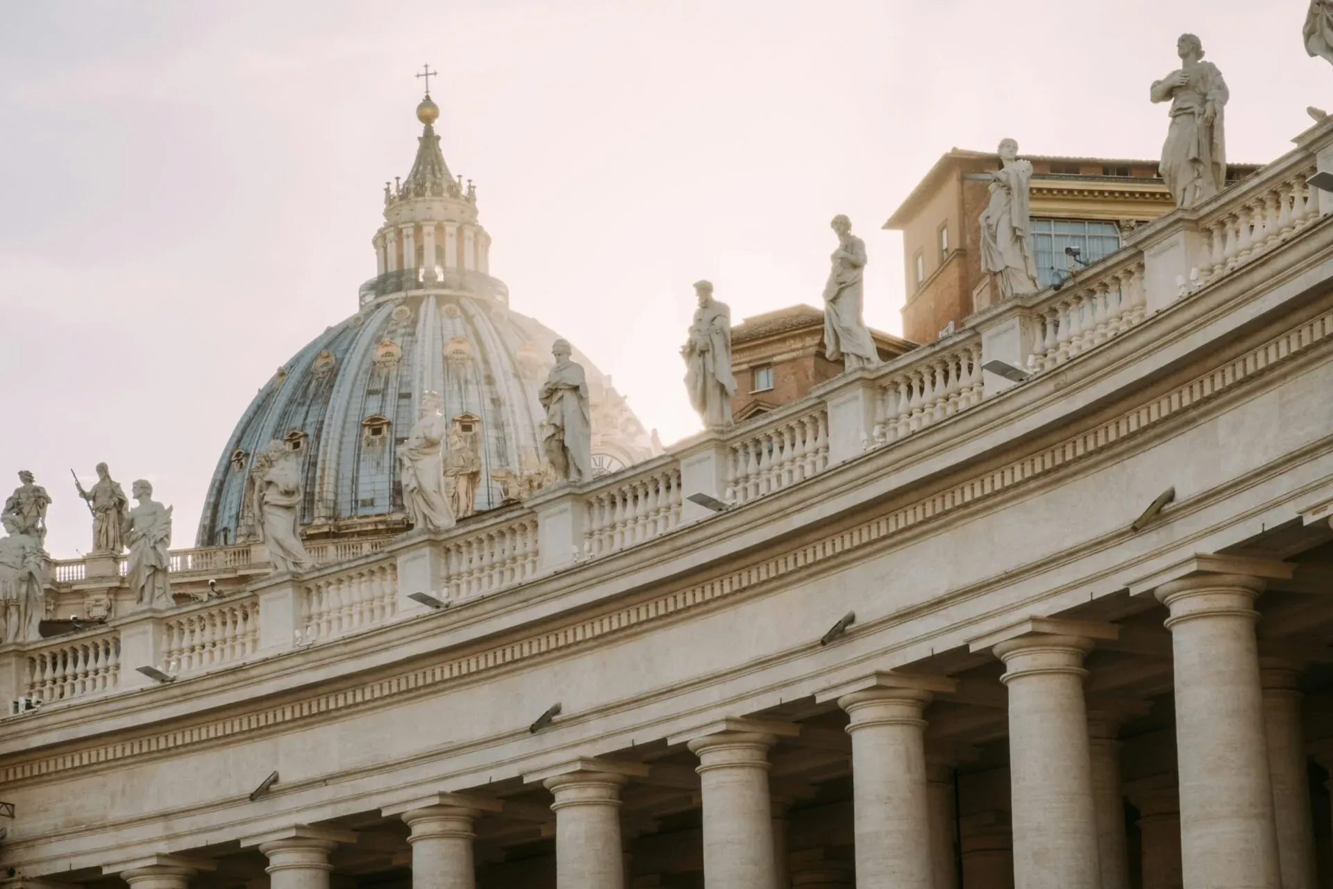 Statues and the dome of St. Peter's Basilica in Rome.