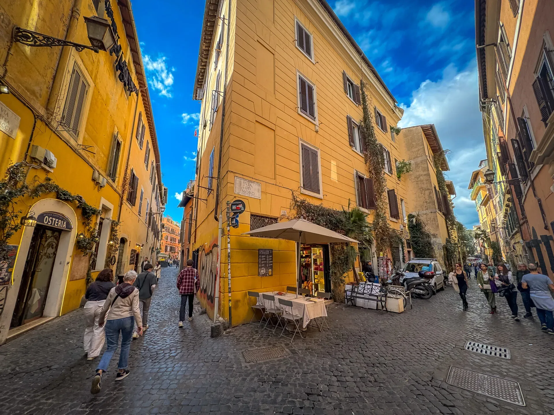 Tourists exploring the charming cobblestone streets of Trastevere, Rome.