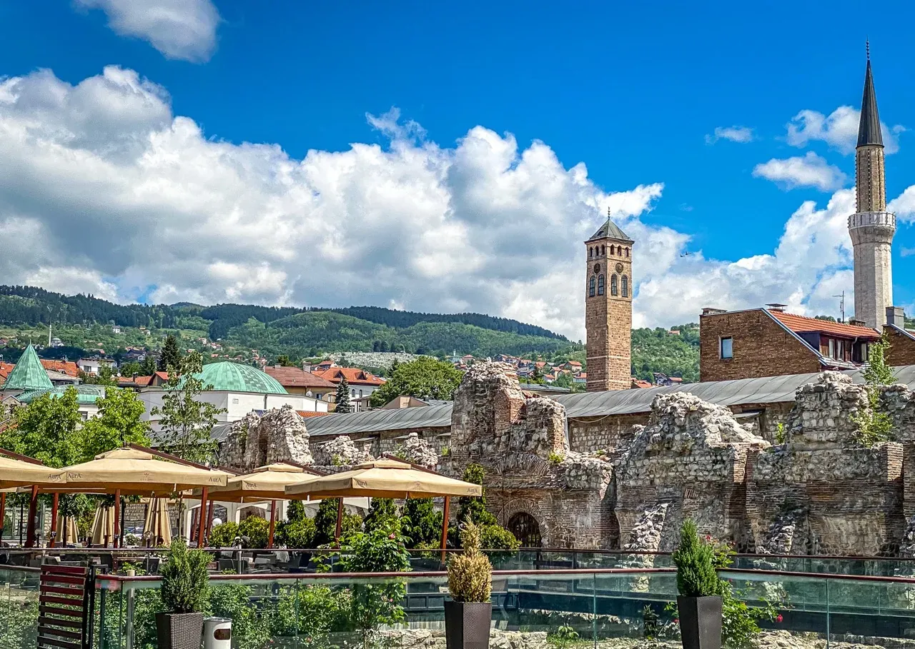 Sarajevo's Clock Tower and Roman ruins, a blend of history and modern life.