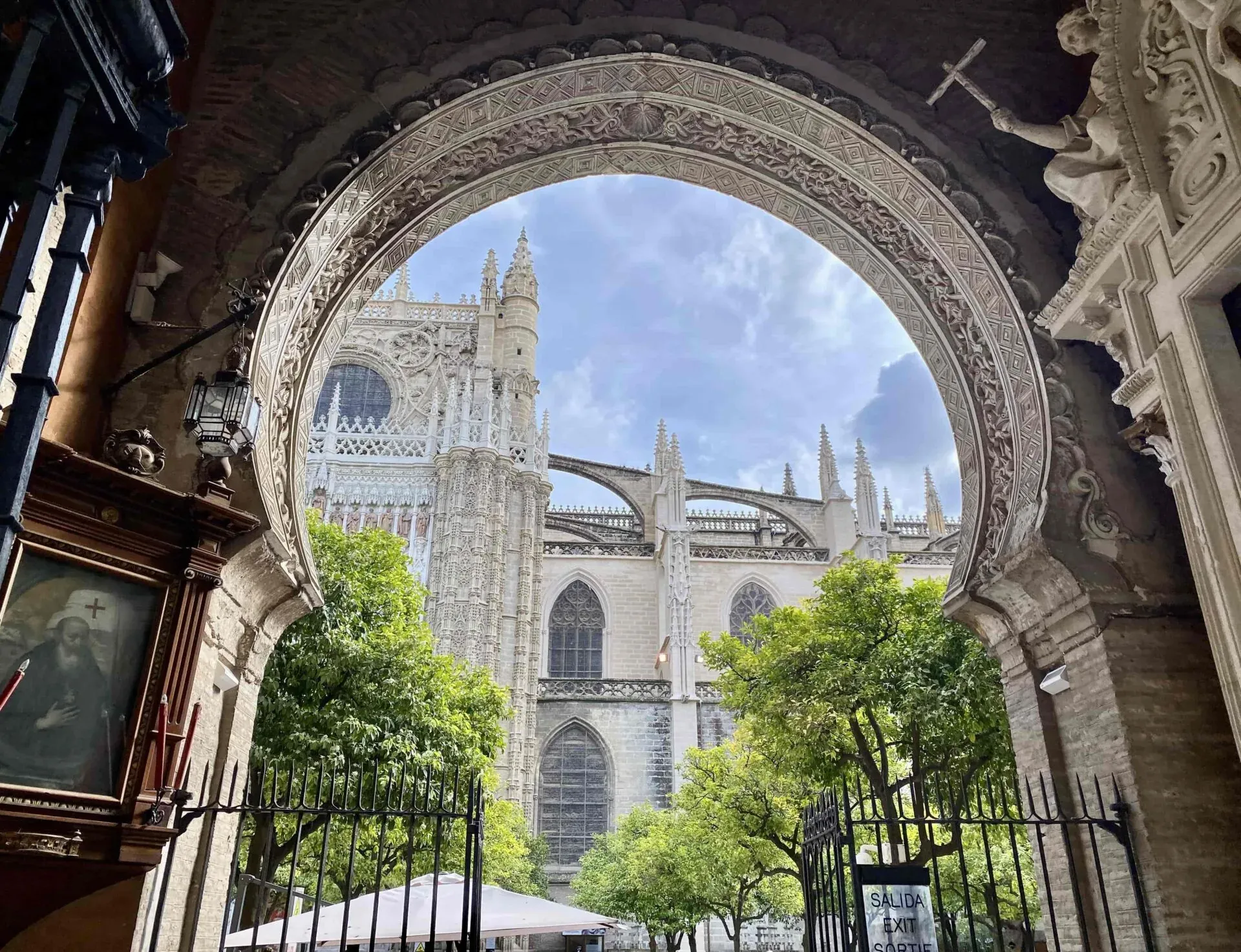 Stunning view of Seville Cathedral through an ornate archway.