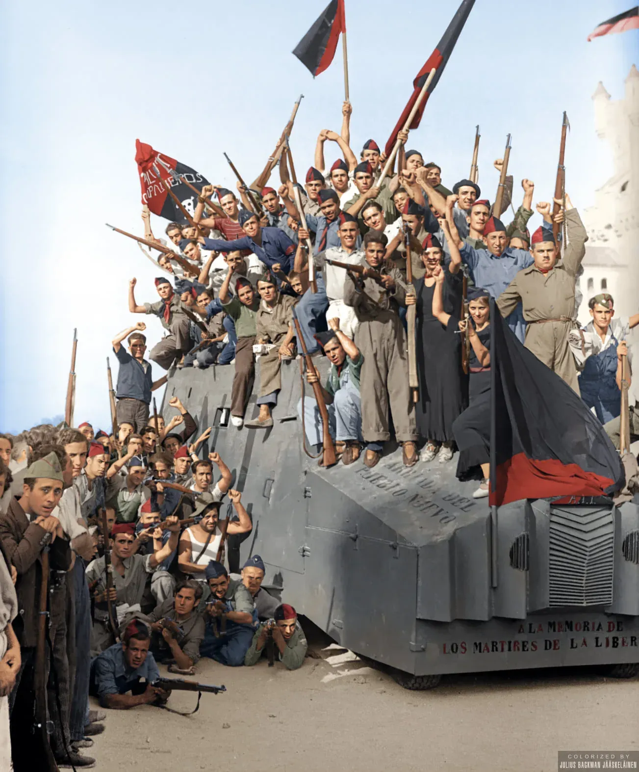 Spanish Republican soldiers celebrate atop an armored car during the Spanish Civil War.