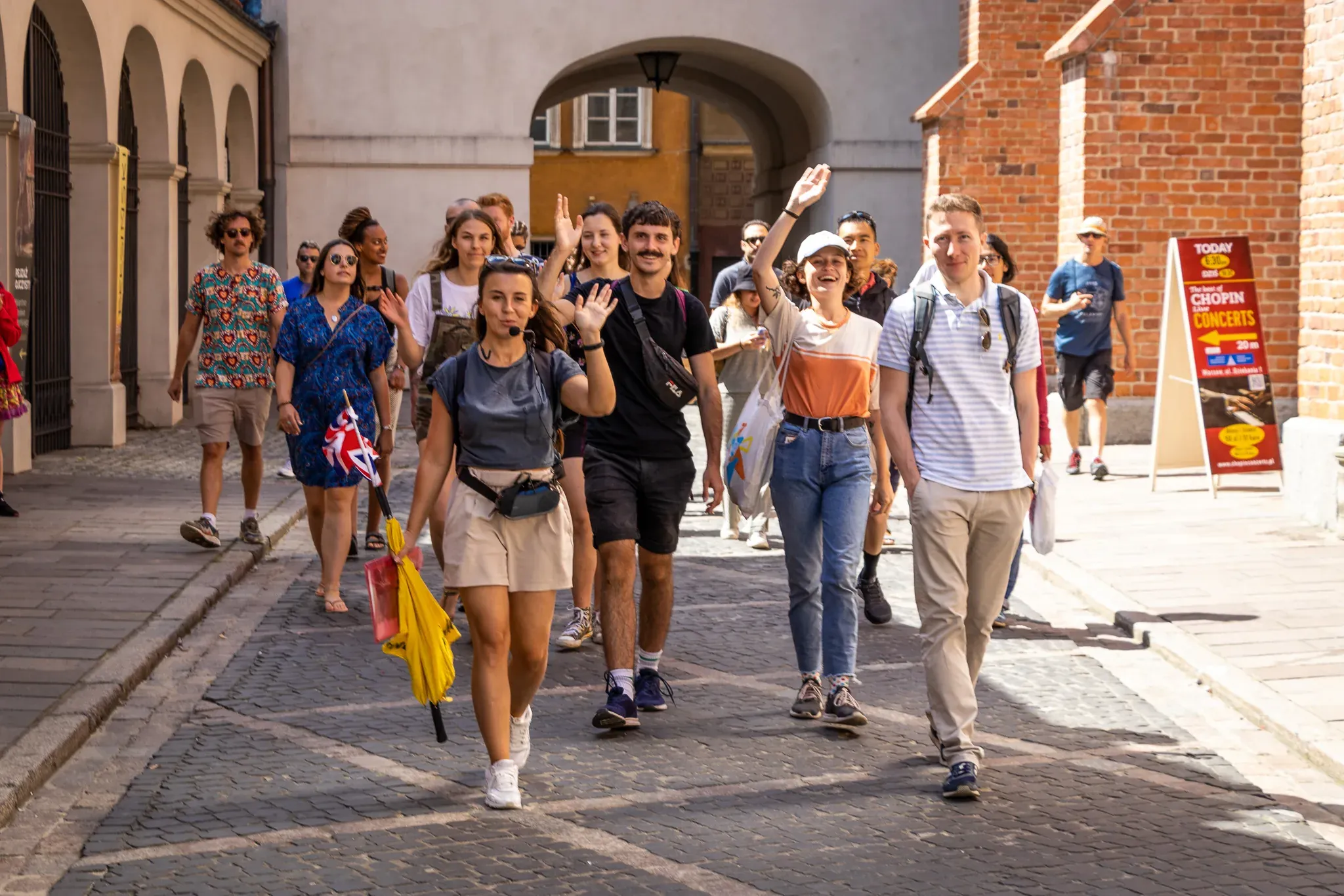 Happy tourists on a guided walking tour in Warsaw's Old Town.
